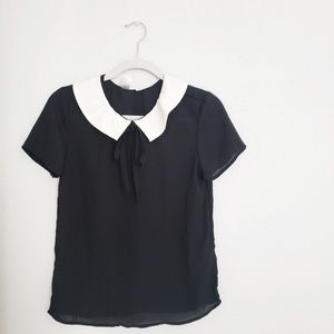 Black sheer top with a white Peter pan collar and